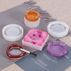 Various geometric silicone molds for DIY resin ashtrays shown with finished samples