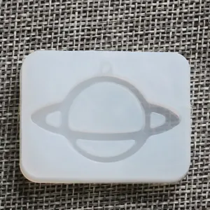 Planet shaped silicone mold with hanging hole for DIY crystal epoxy resin crafts.