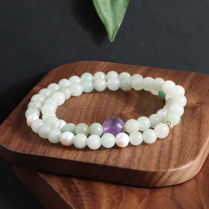 Detailweergave van een dubbellaagse armband met amethist, jade en zoetwaterparels.