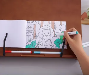 Detailed view of hand coloring a lion illustration in a children's coloring book
