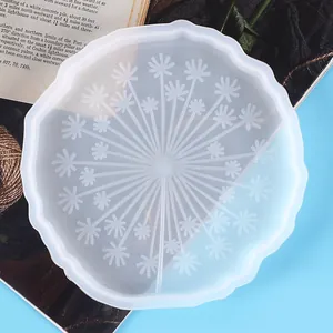 Detailed macro view of a translucent silicone coaster mold with a dandelion pattern