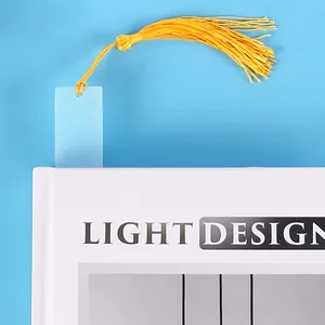 Nahaufnahme eines DIY halbtransparenten Lesezeichens mit goldener Quaste auf einem Buch
