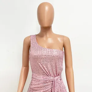 Detail shot of pink sequin one-shoulder dress showing pleats and shimmering texture