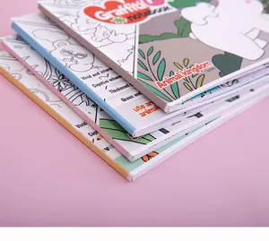 Macro view of stacked children's coloring books showing English educational titles on spines