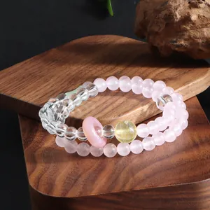 Close-up detail of double-layer crystal bead bracelet with pink and yellow accents