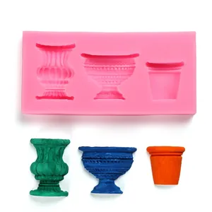 Detailed view of pink silicone mold with three retro vase shapes and colored samples