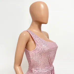 Detail view of a pink one-shoulder sequin dress with elegant waist pleats and shimmer texture.