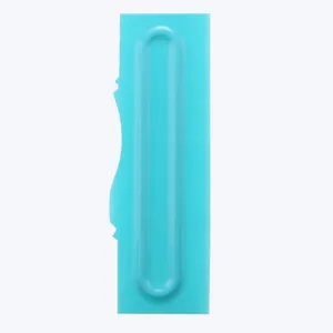 Detail view of a blue plastic cake scraper with a wavy pattern edge for fondant