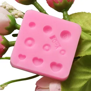 Detailed macro view of a pink silicone mold with heart and circular textured patterns for baking