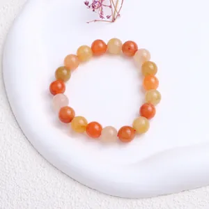 Naturfarbenes Goldsidene Jade Perlenarmband mit warmen Orange- und Gelbtönen