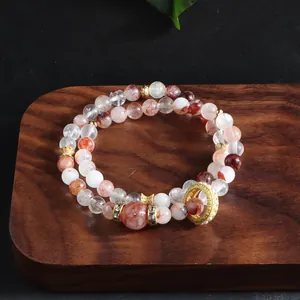Macro view showing the natural texture of red lepidocrocite quartz and gold spacers