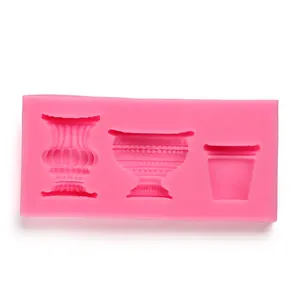 Detail of pink silicone mold with retro vase, cup and pot shapes for cake decorating