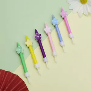 Detail view of colorful flower-decorated birthday candles in various pastel shades