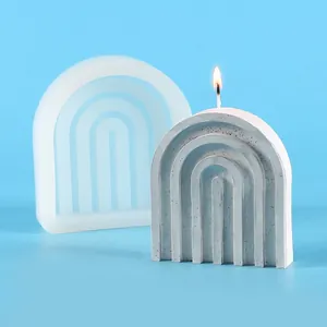 Detailed view of a U-shaped rainbow arch silicone mold alongside a finished burning candle