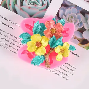 Detailed macro view of pink silicone flower mold and finished colorful floral plaster craft