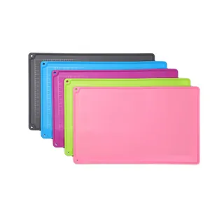 Detailed view of multi-color silicone kneading mats with printed measurement scales