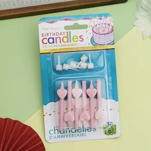 Detail view of 6 pink heart-shaped birthday candles in retail packaging with holders