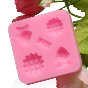Detail view of pink silicone mold with fish and waffle cavities for baking