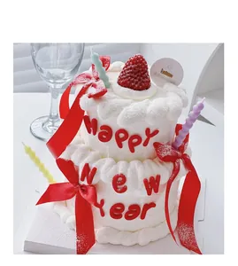 Detailed view of New Year cake decoration ornament featuring red Happy New Year letters