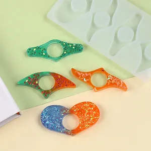 Detailed view of colorful glittery resin thumb book holders with their silicone mold