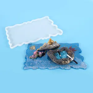 Detail of irregular silicone tray mold and finished mountain-themed resin display.