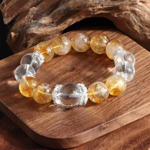 Detailed macro view of natural citrine and clear quartz beaded bracelet with silver floral spacers