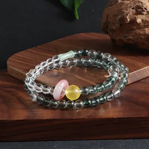 Macro detail of a double-layered crystal bracelet with multi-colored gemstone accents