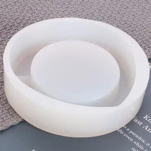 Close-up view of a large round white silicone mold for DIY crystal epoxy resin ashtray