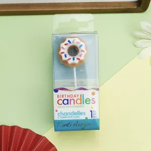 Close-up of a cute donut-shaped birthday candle in its clear plastic display packaging