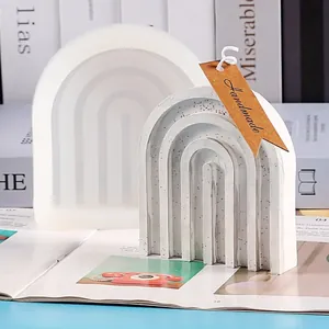 Detailed view of a U-shaped rainbow bridge silicone mold with a finished plaster piece.