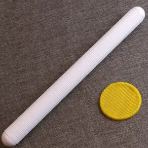 Close-up detail of white dotted rolling pin for fondant embossing and cake baking decor