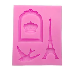 Pink silicone mold featuring Eiffel Tower, crown, and bird shapes for baking and crafts