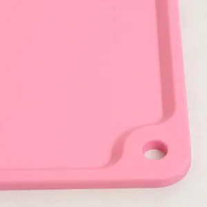 Detailed macro view of pink silicone kneading mat corner featuring molded measurement scales