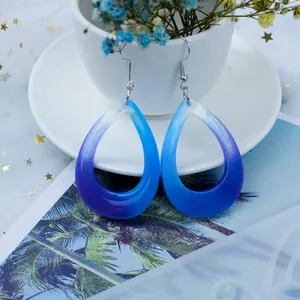 Handmade teardrop resin earrings featuring a vibrant blue and purple gradient finish.