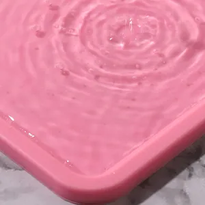 Close-up of pink silicone kneading mat with water ripples showing waterproof surface