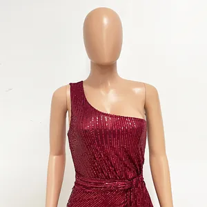 Detail of burgundy one-shoulder sequin dress with elegant waist tie and shimmering texture