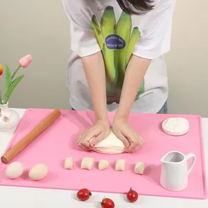 Pink silicone kneading mat with raised edges for non-stick home baking use