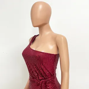 Close-up detail of burgundy sequin one-shoulder dress with elegant waist sash tie.