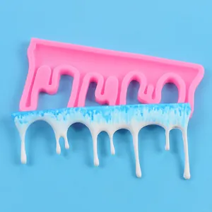 Detail of pink silicone mold and white dripping ornament for baking and crafts
