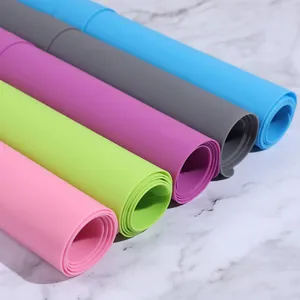 Macro view of colorful rolled silicone baking mats showing smooth texture and various colors