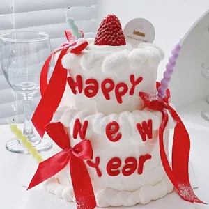 Happy New Year red soft rubber cake topper ornament with festive ribbon and candles