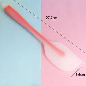 Silicone baking spatula with dimensions 27.7cm by 5.6cm shown on pastel background