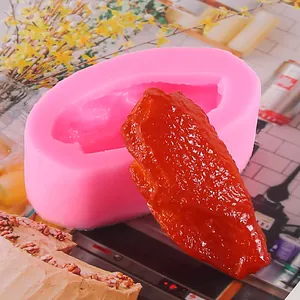 Detail of 3D realistic chicken wing silicone mold with finished food model replica