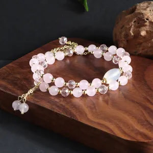 Double-strand pink quartz bead bracelet with elegant gold tassel and faceted crystals
