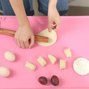 Close-up of pink silicone baking mat with measurement markings used for rolling dough