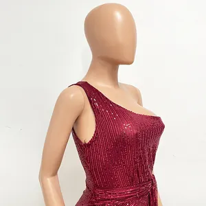 Close-up detail of a wine red one-shoulder sequin evening gown with elegant pleats