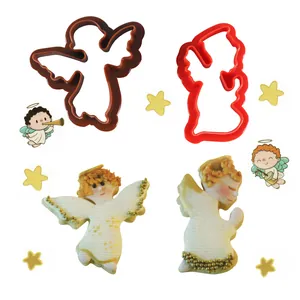 Vista detallada de cortadores de galletas de ángel con galletas decoradas terminadas.