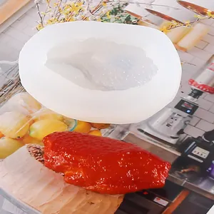 Detailed macro view of the white silicone mold and finished chicken wing resin casting project