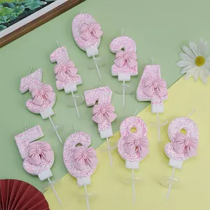 Set de velas de cumpleaños numéricas rosas brillantes con lazos 3D para decorar tartas