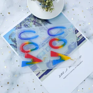 Geometric silicone mold for DIY crystal resin earrings with colorful finished resin pieces